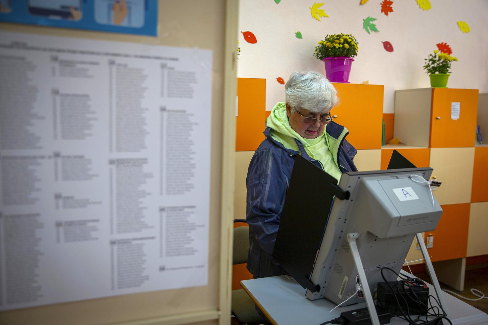A woman casts her vote at a polling station in Bankya, Bulgaria.