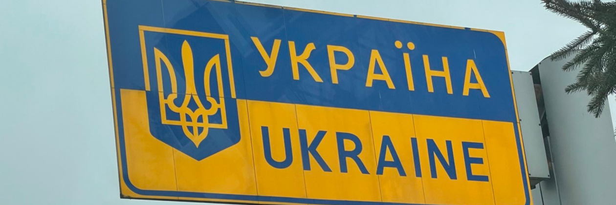 Road sign at border reads Ukraine in English and Ukrainian 