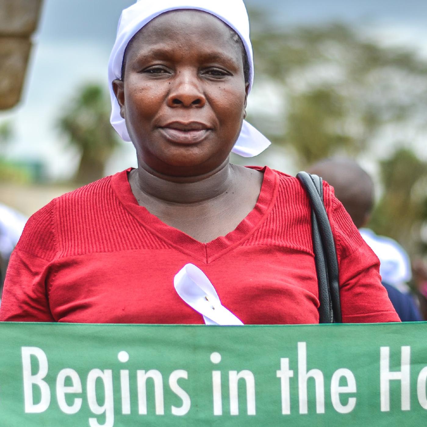 A Kenyan woman holding peace campaign banner