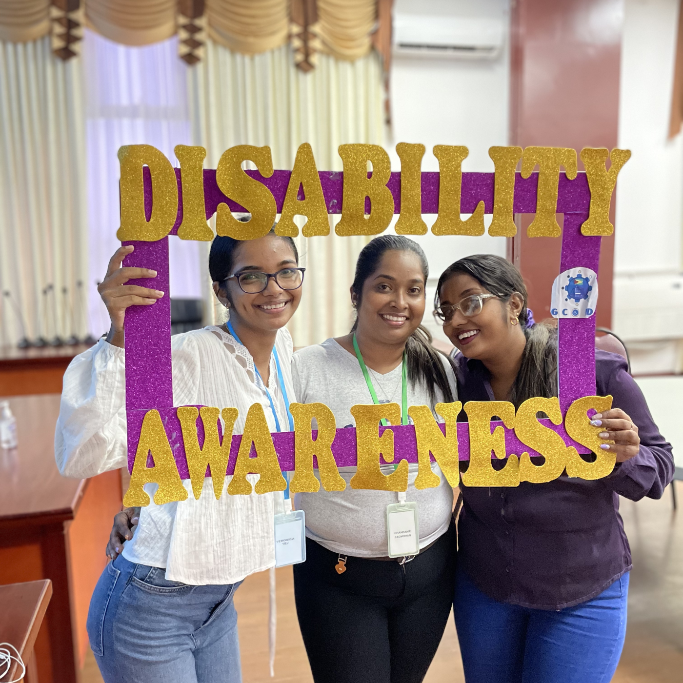 Youth with the conference's selfie frame promoting disability awareness
