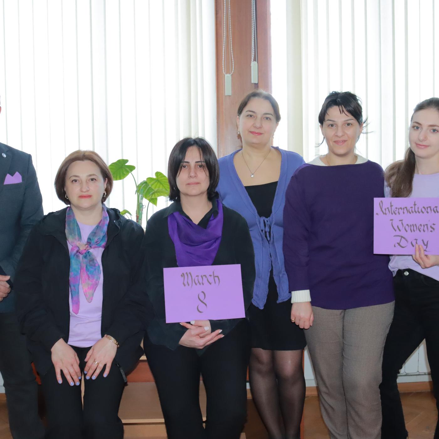 IFES Georgia in purple with purple signs for IWD 2023