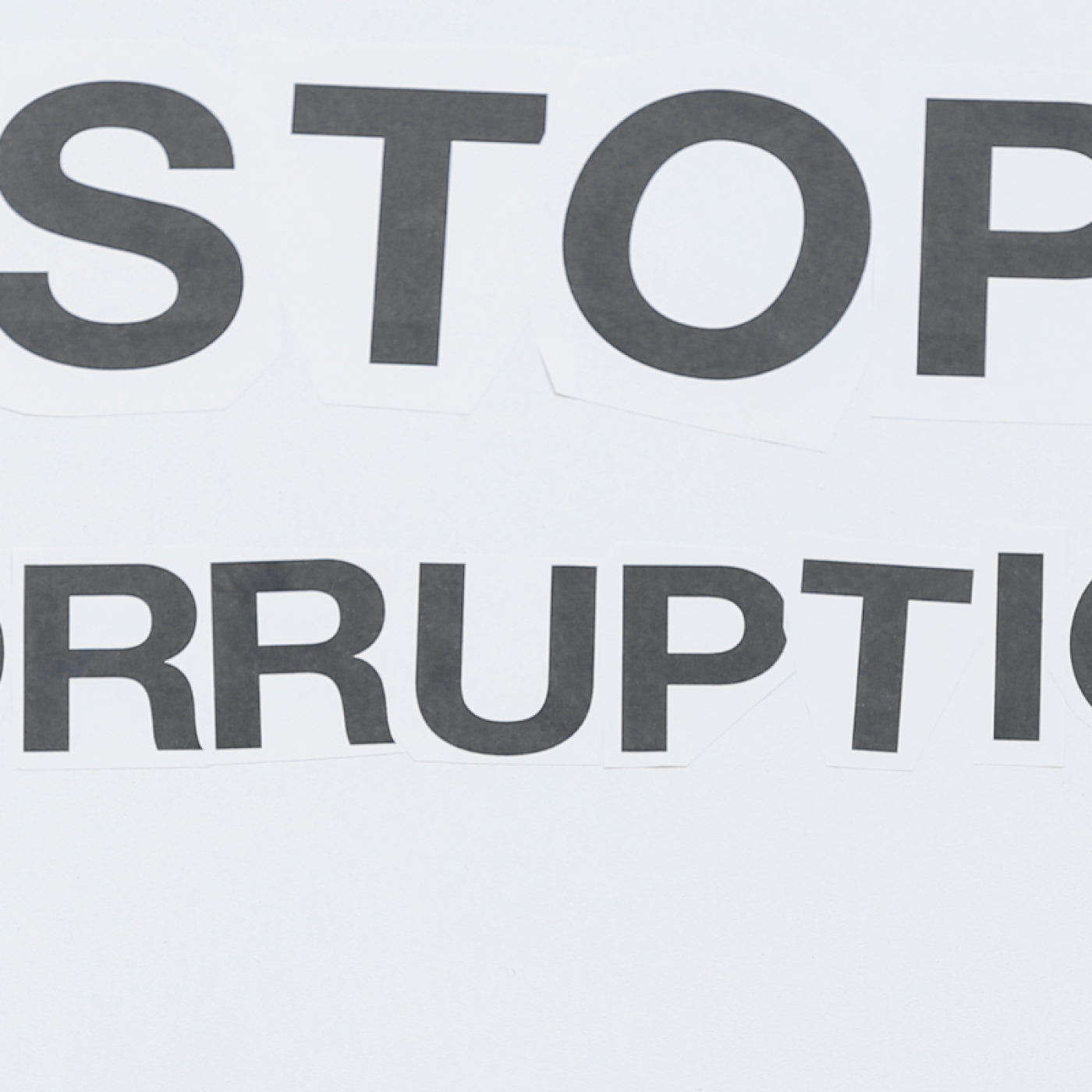 woman holding placard that says stop corruption outdoors. photo credit pixelshot 