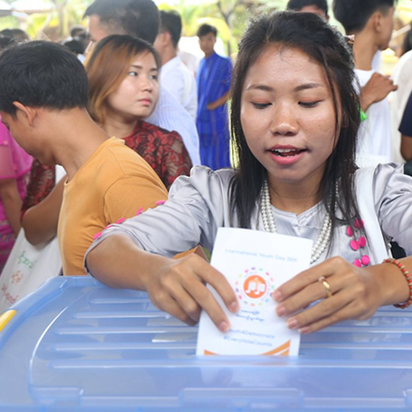 A young participant learns how to properly cast a ballot at the UEC mock polling station.
