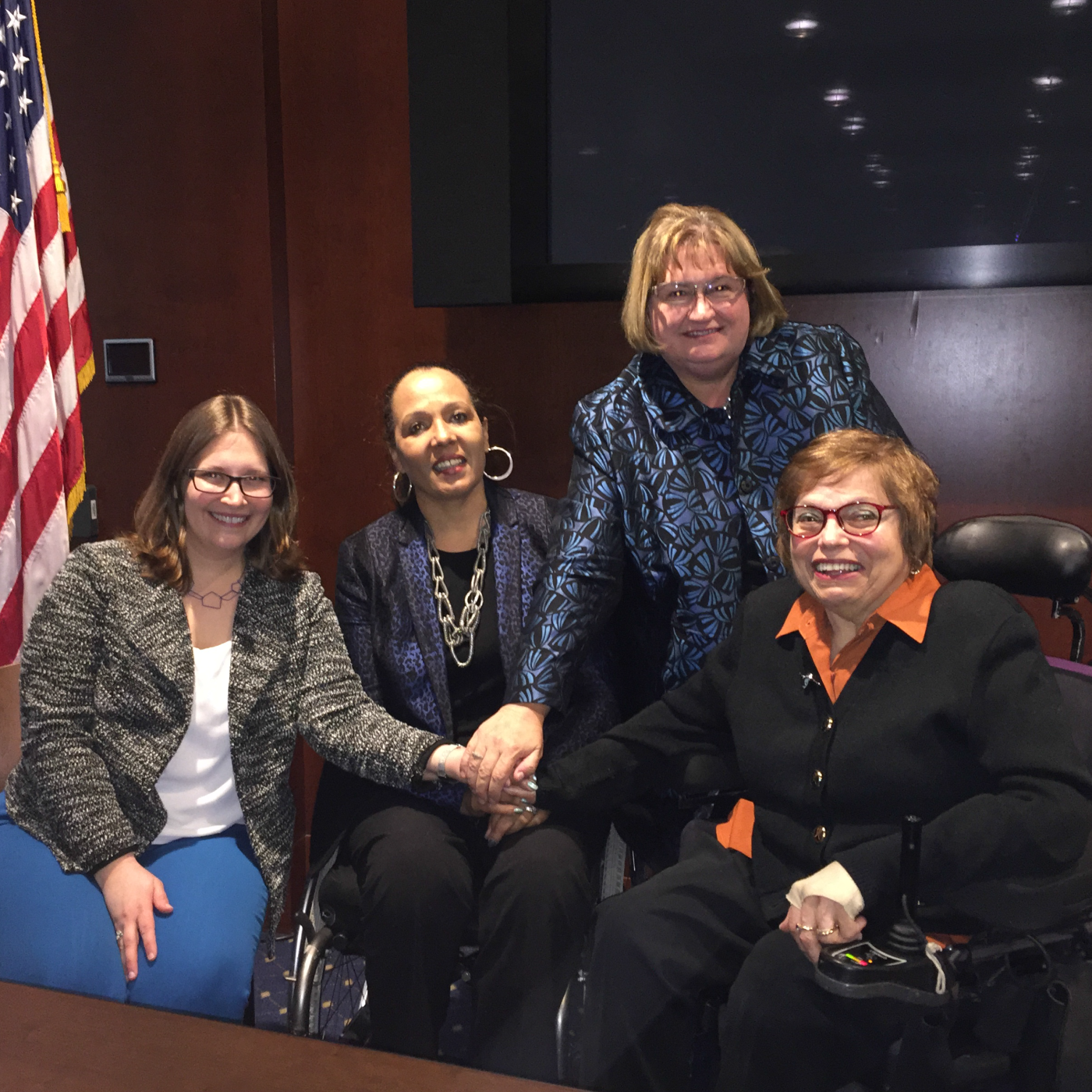 Panelists Virginia Atkinson, Judith Heumann, Isabel Hodge, and Charlotte McClain-Nhlapo pose for a photo post-discussion.
